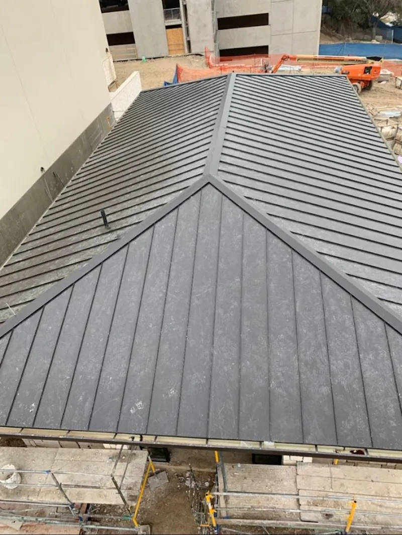 Commercial metal roof construction with crane equipment in Yorktown